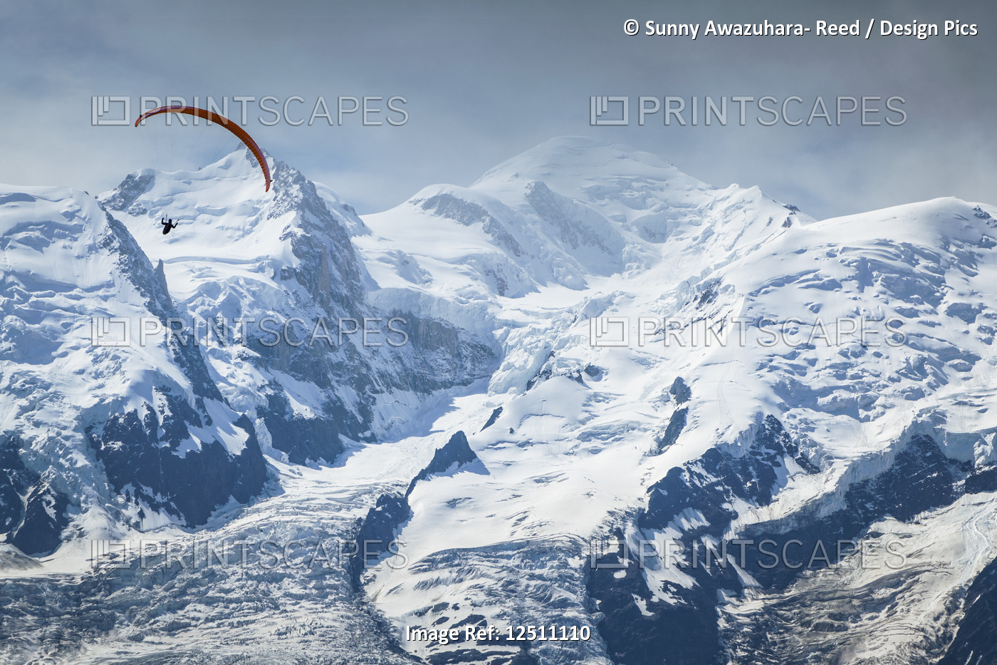 A paraglider flying over Mount Blanc in summer, Alps; Chamonix-Mont-Blanc, ...