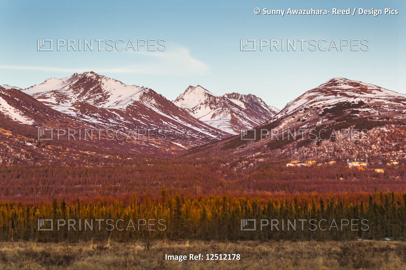 Sunset glow on Chugach Mountains and hillside houses, viewed from Anchorage, ...
