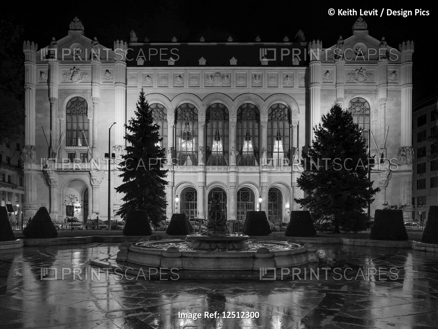 Exterior of a building illuminated at nighttime by light, a frozen pool and ...
