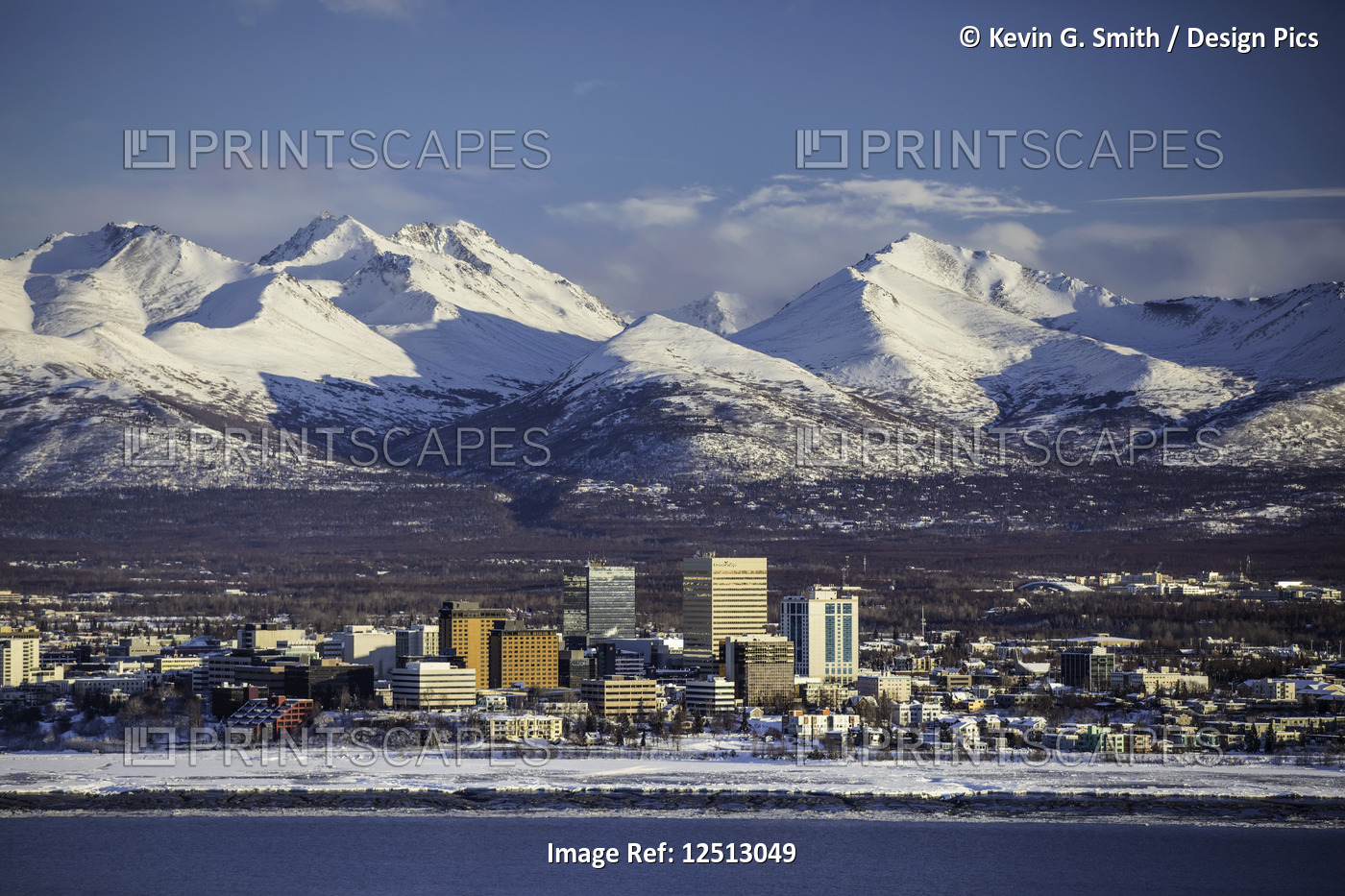 Snow-covered downtown Anchorage with the Chugach Mountains directly in the ...