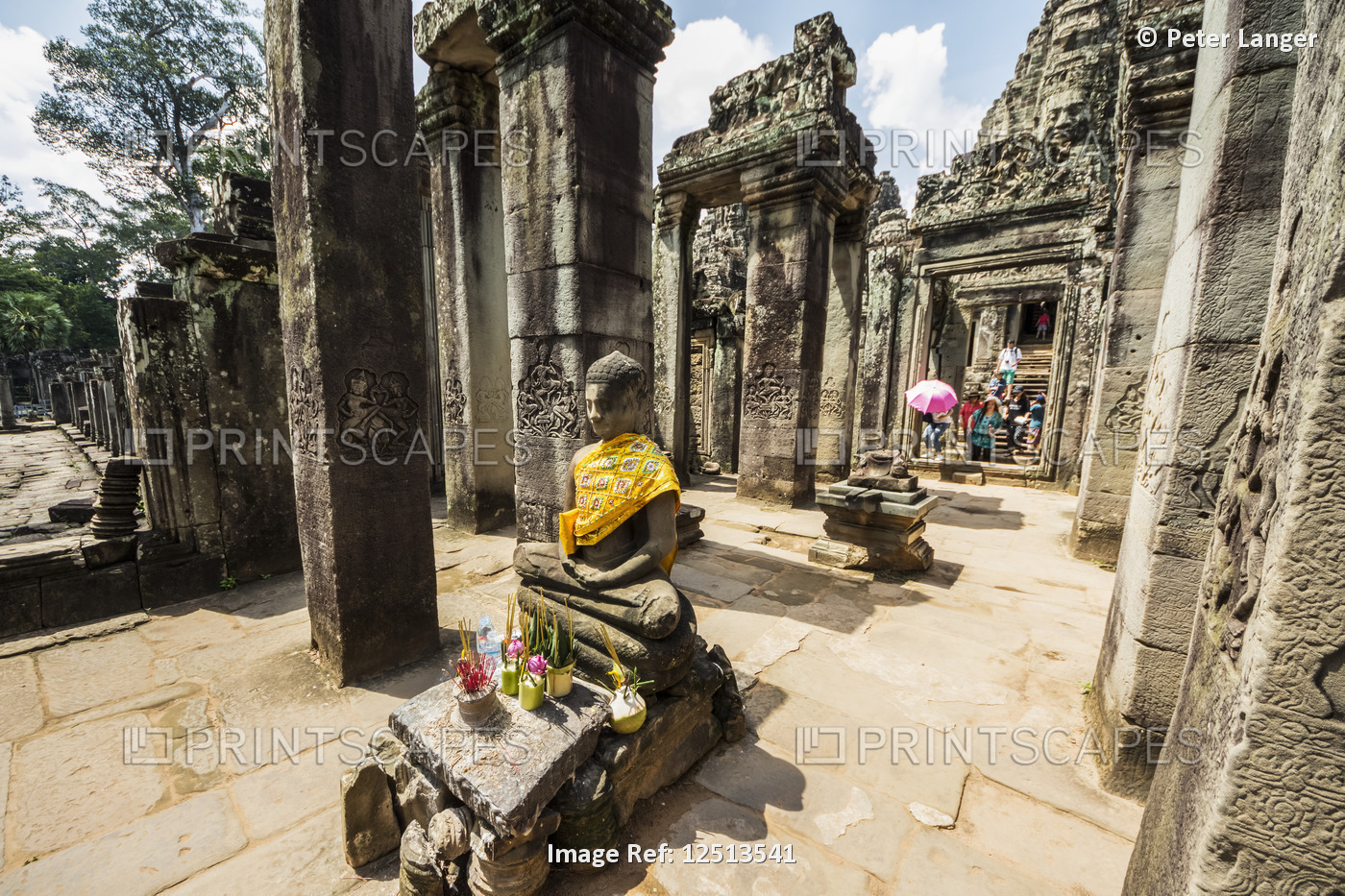 Buddha statue and North face of the Bayon, Angkor Thom; Siem Reap, Cambodia