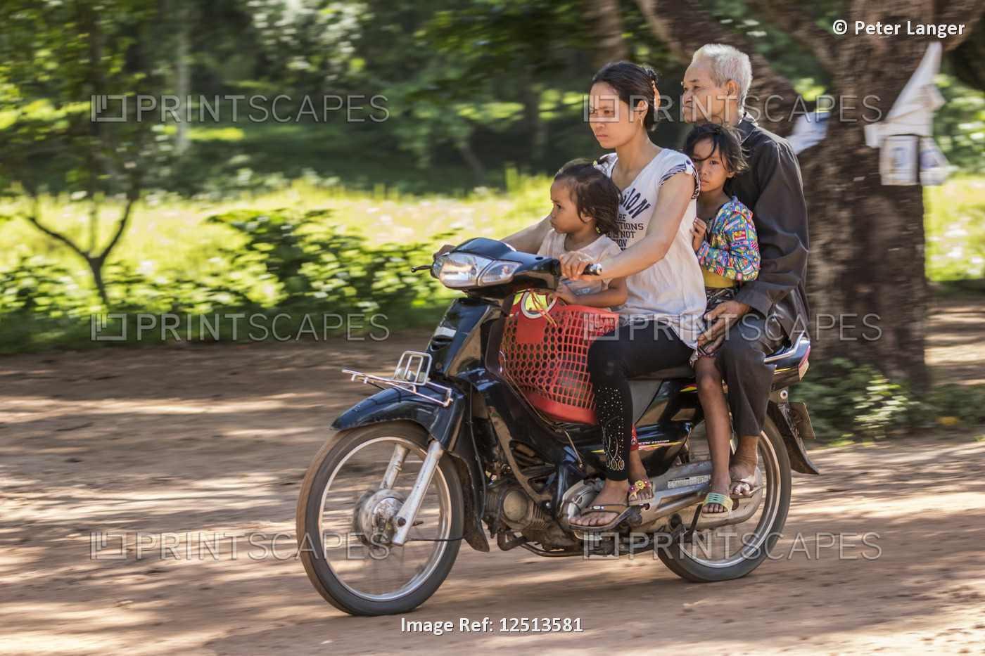 Cambodian family riding a motorcycle, Beng Meala; Siem Reap, Cambodia
