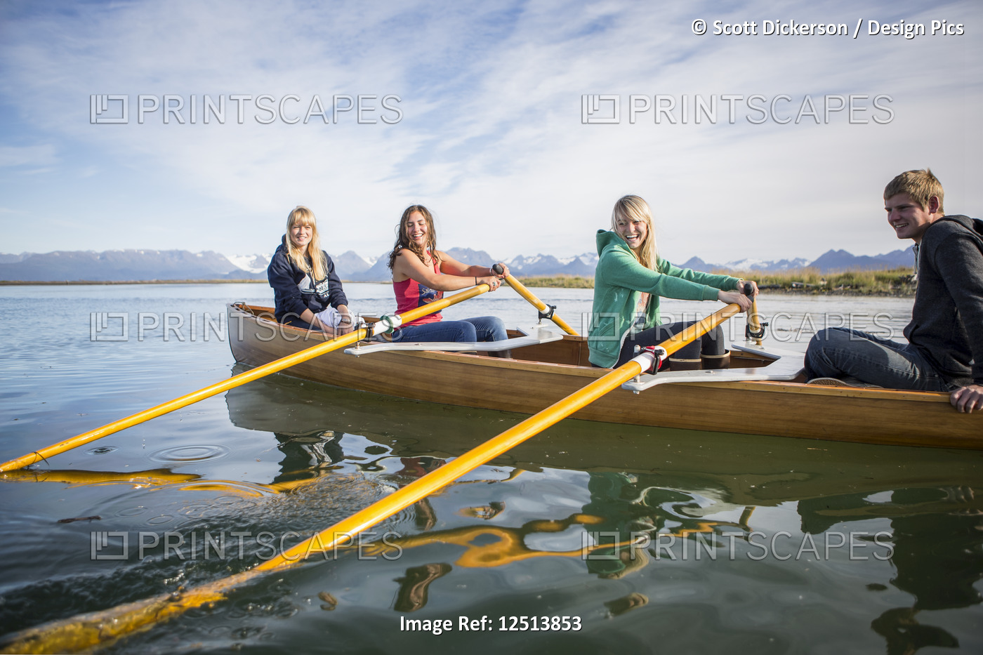Young adults rowing in a canoe, South-central Alaska; Homer, Alaska, United ...