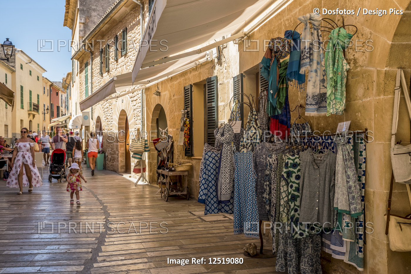 Small shops along a narrow street; Alcudia, Mallorca, Balearic Islands, Spain
