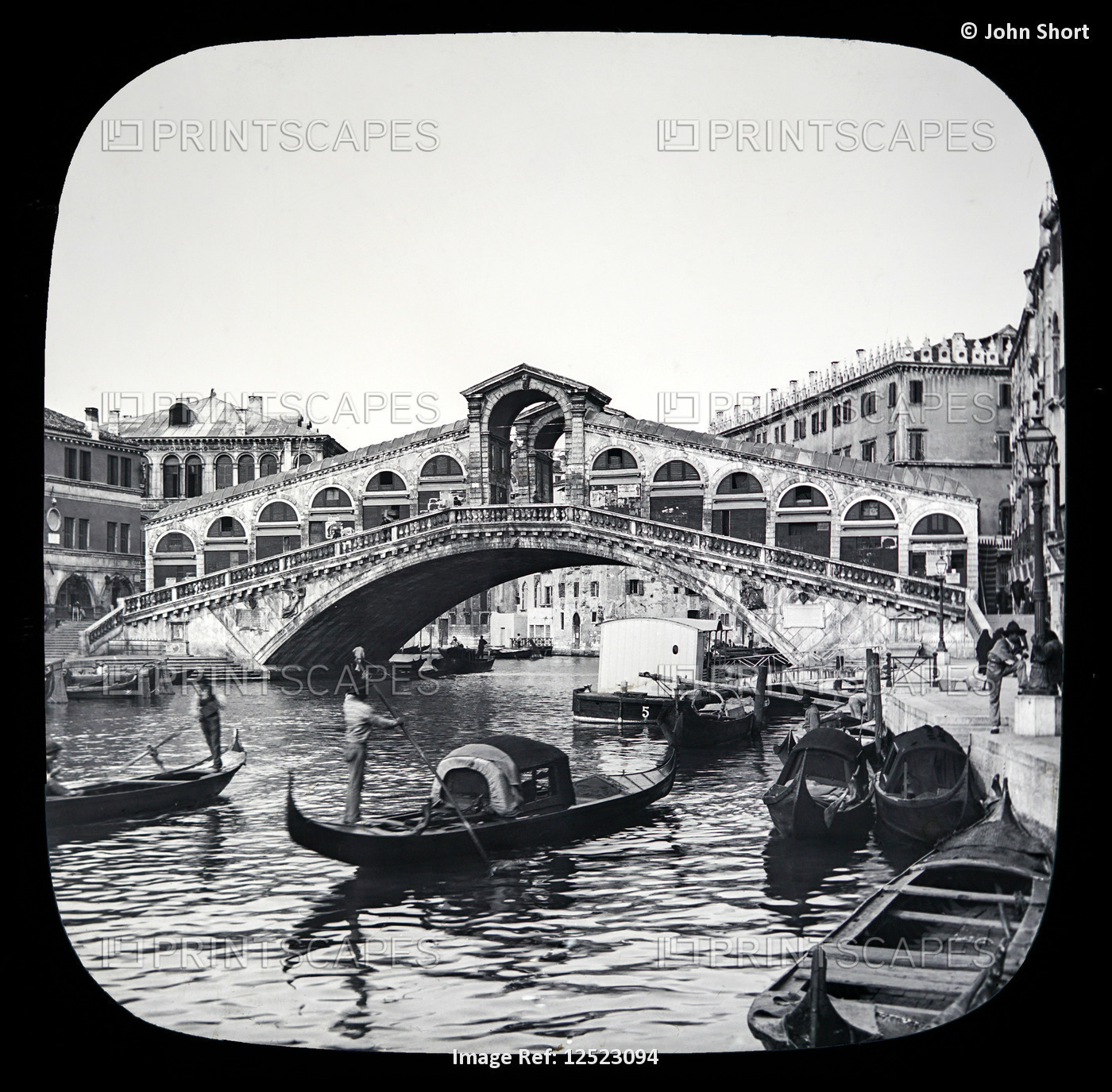 Rialto Bridge and gondolas with gondoliers in the Grand Canal, Venice circa ...