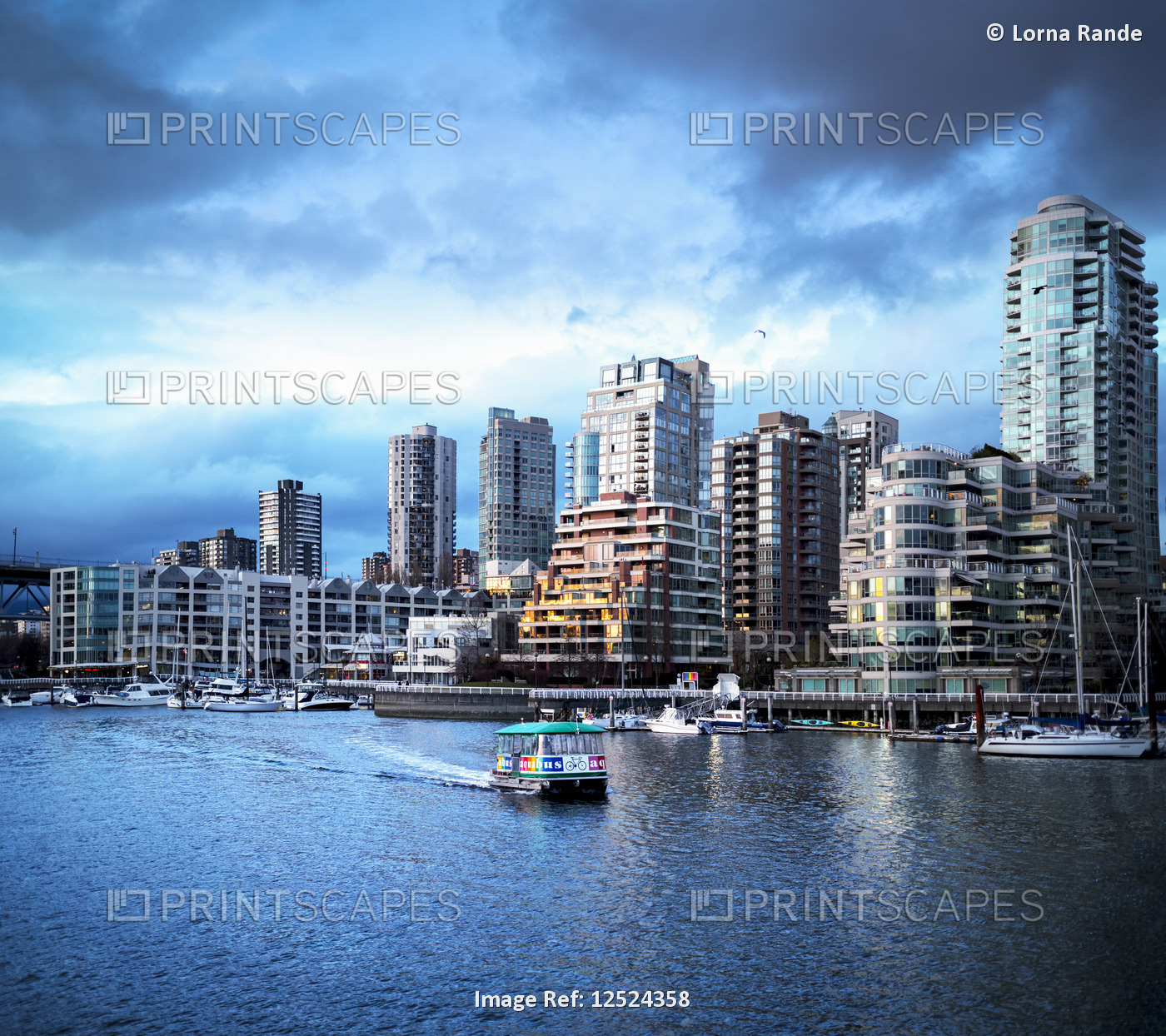 Sunset over Yaletown with boats in the harbour; Vancouver, British Columbia, ...