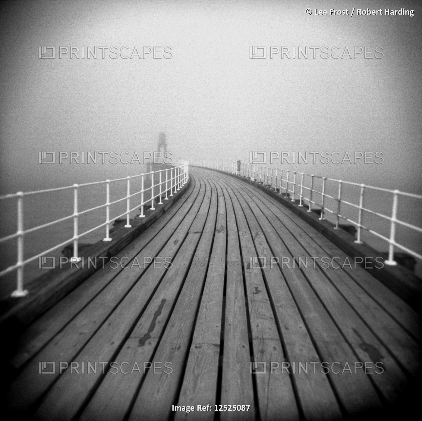 Image taken with a Holga medium format 120 film toy camera looking along timber boardwalk of Whitby 