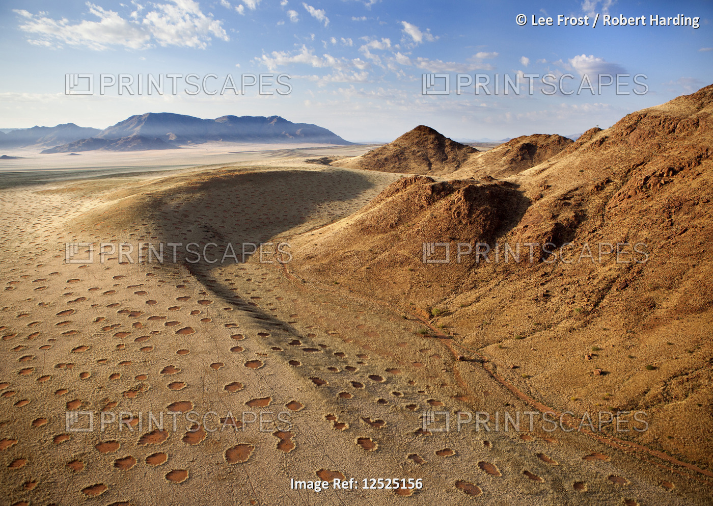 Aerial view from hot air balloon over magnificent desert landscape of sand dunes, mountains and Fair