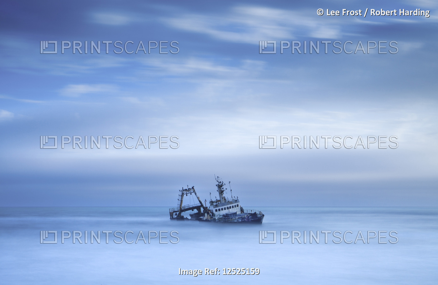 Shipwreck off the Atlantic coast, shot with long exposure to record motion in sea and sky, near Walv