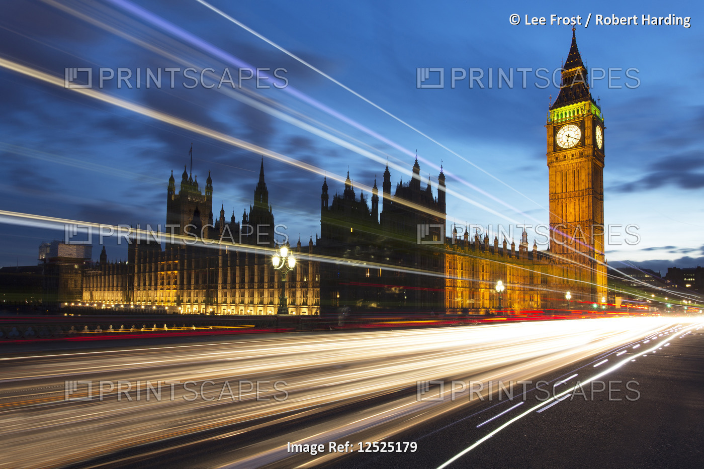 Houses of Parliament and Big Ben floodlit at night with colourful light trails from passing traffic 