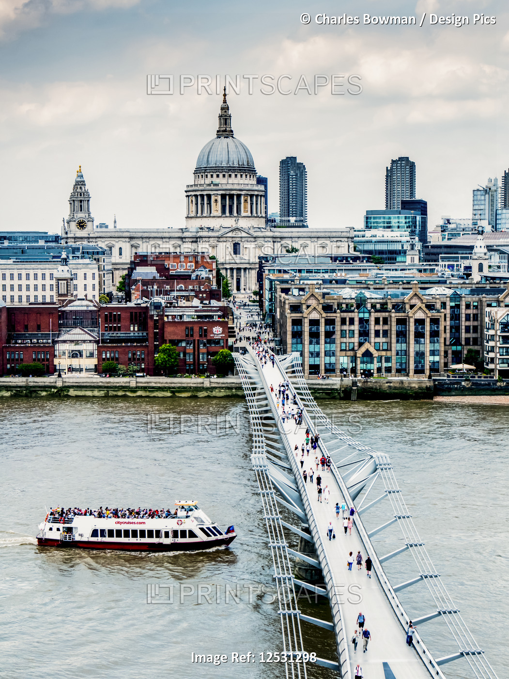 Tourists on Millennium Bridge with St. Paul's Cathedral in the background, ...