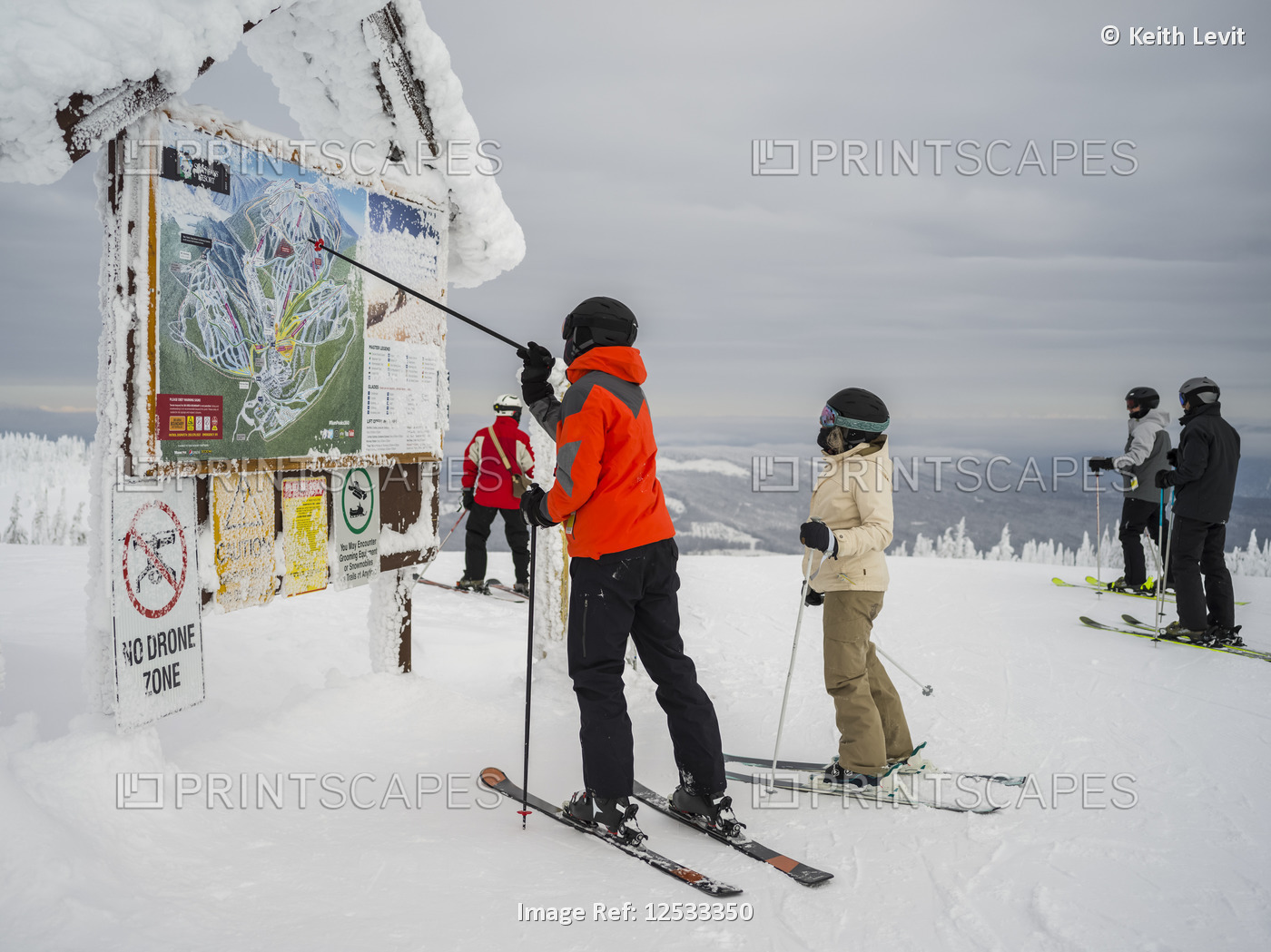 Skiers look at a map at Sun Peaks ski resort; Kamloops, British Columbia, Canada