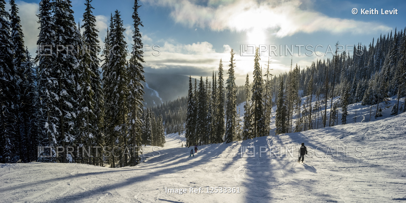 Skiers on a run at Sun Peaks ski resort; Kamloops, British Columbia, Canada