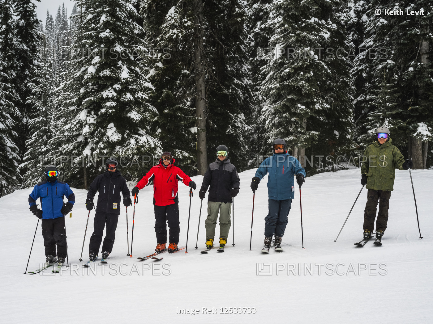 Skiers standing in a row, Sun Peaks Resort; Kamloops, British Columbia, Canada