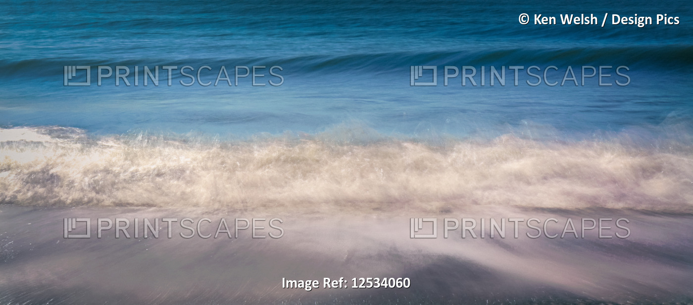 Waves breaking on shore; Spain