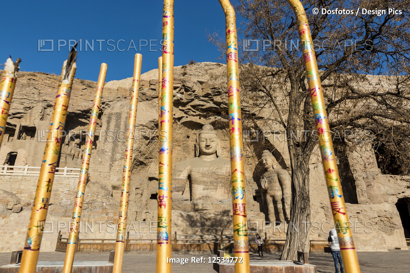 Incense sticks near the carved Buddha statues at Yungang Grottoes, ancient ...
