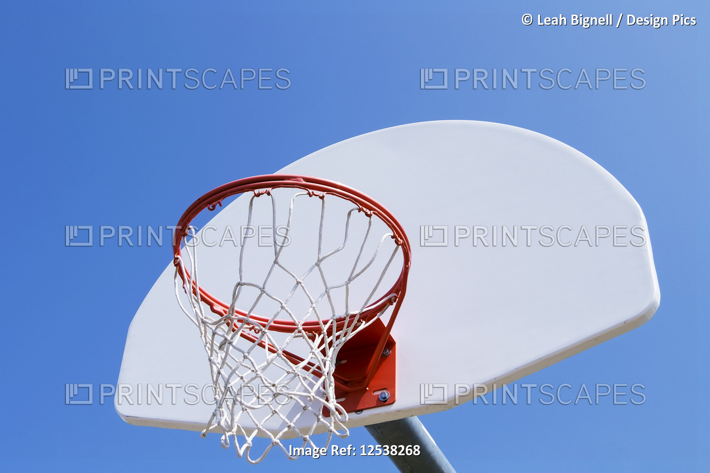 A basketball hoop on an outdoor court against a blue sky; Stony Plain, Alberta, ...
