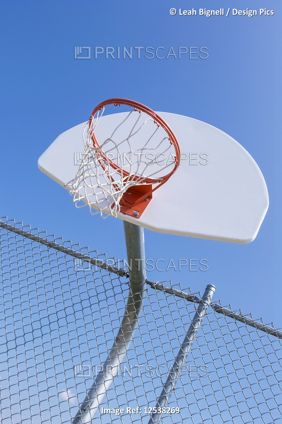 A basketball hoop on an outdoor court against a blue sky; Stony Plain, Alberta, ...