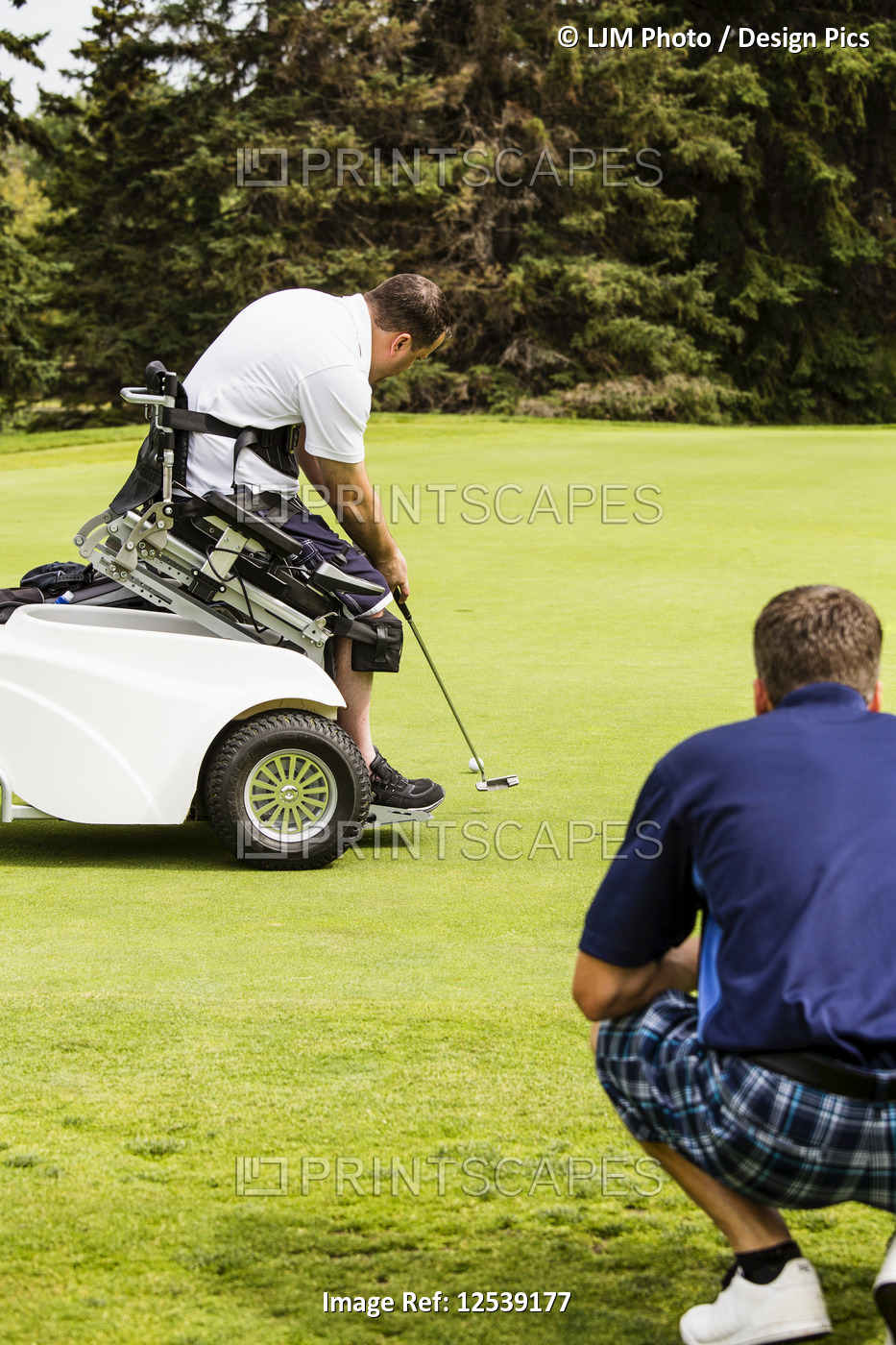 An able bodied golfer teams up with a disabled golfer using a specialized ...