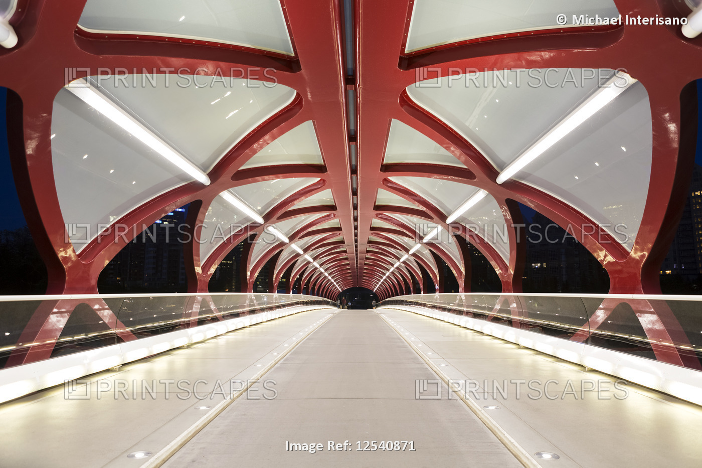 The Peace Bridge, glowing lights inside a red pedestrian bridge at night; ...
