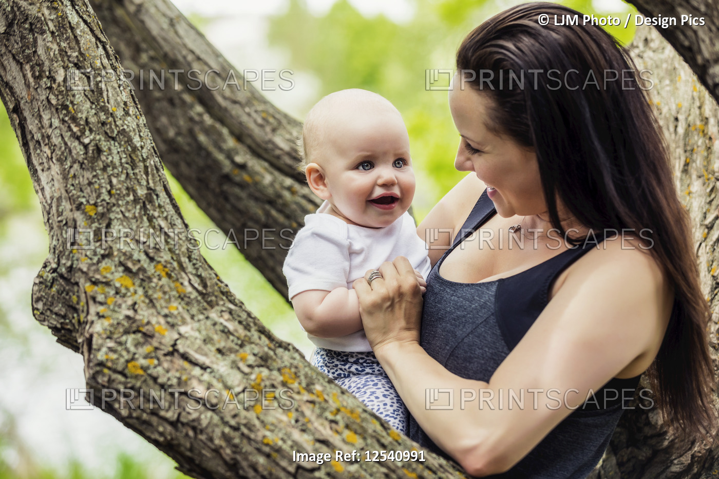 A young mother spending quality time with her daughter in a park during the ...