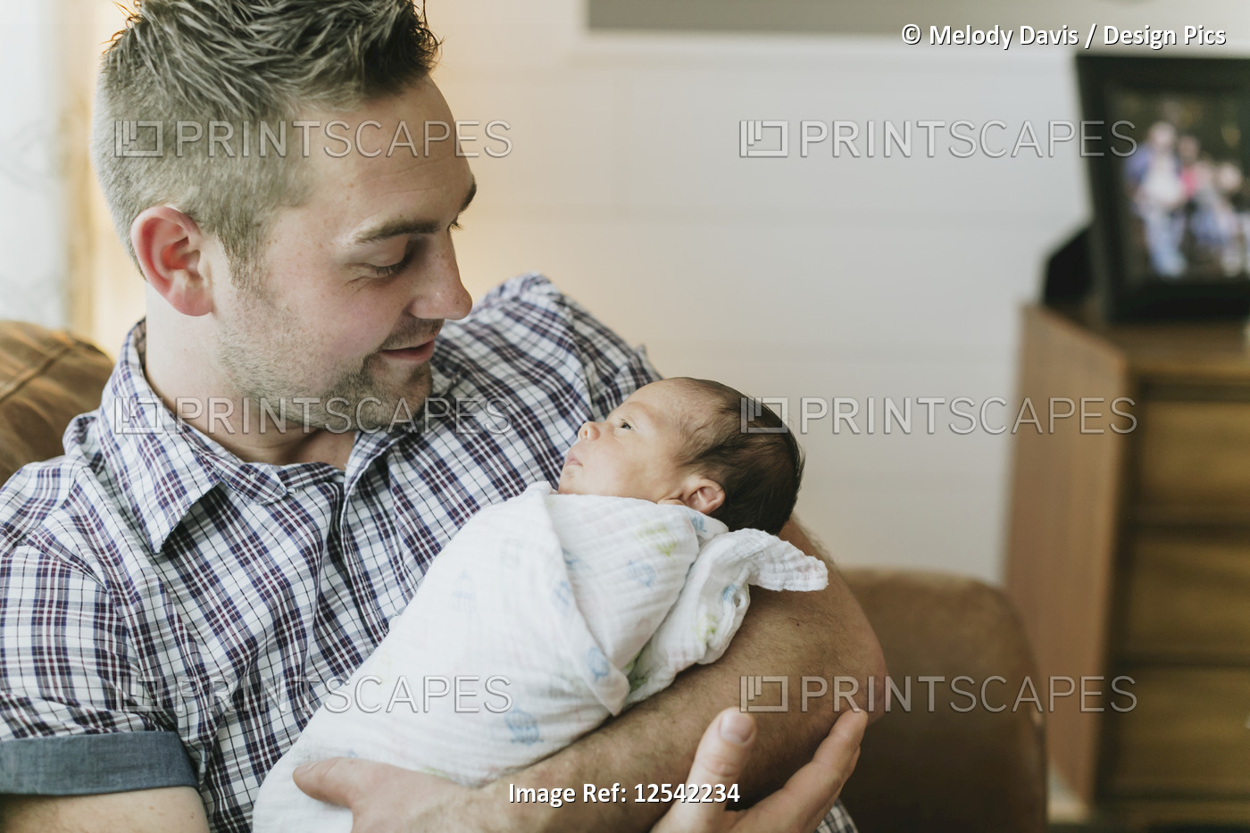 Portrait of a father holding his newborn baby; Surrey, British Columbia, Canada