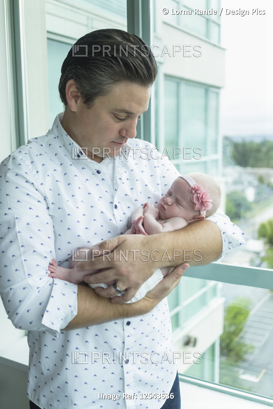A father holds a newborn baby; Surrey, British Columbia, Canada