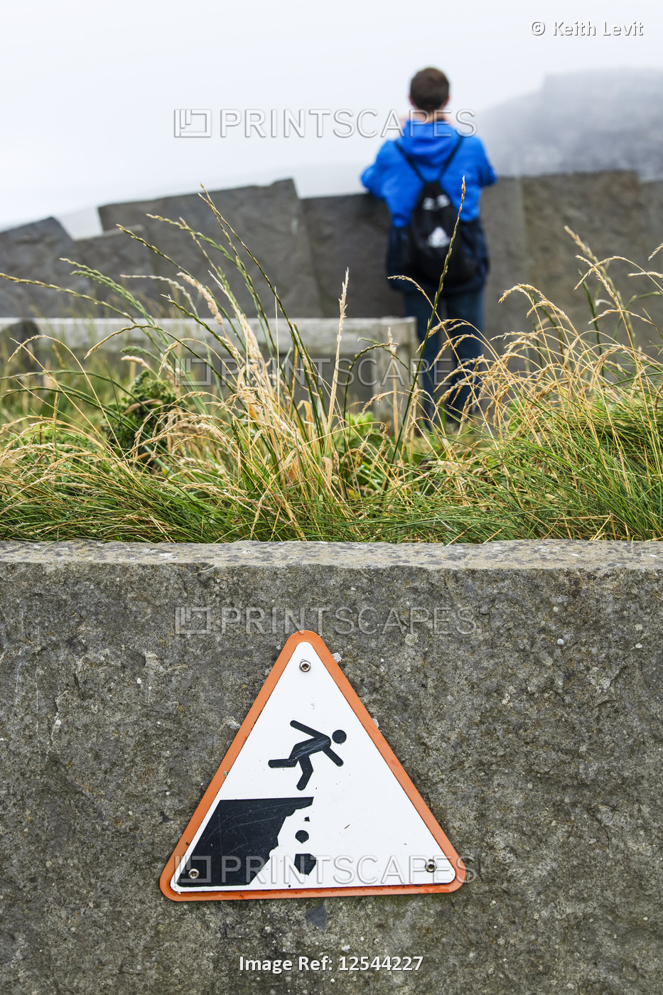 Sign warning of danger on steep cliffs with a pictogram of a tourist falling, ...