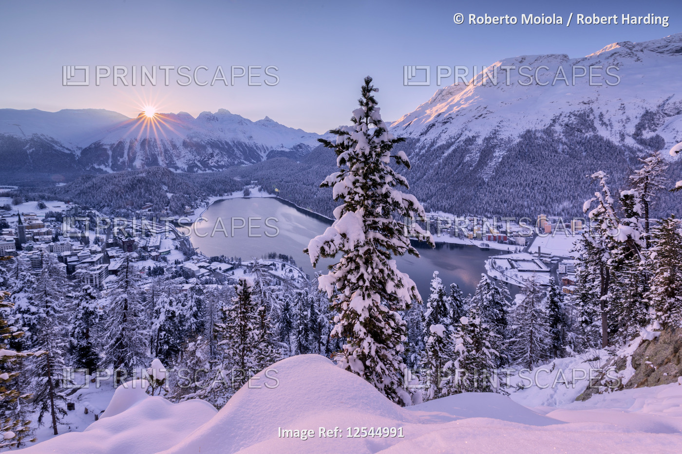 Sunrise on village and Lake of St.Moritz covered with snow, canton of Graubunden, Engadin, Switzerla
