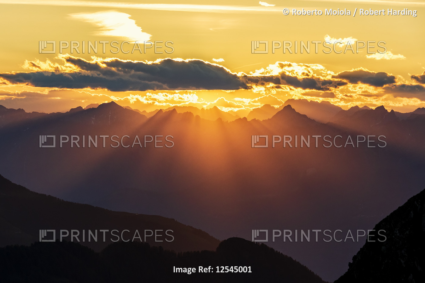 Sun rays at sunset on Pizzo Berro and Gerola Valley seen from San Marco Pass, Orobie Alps, Bergamo p