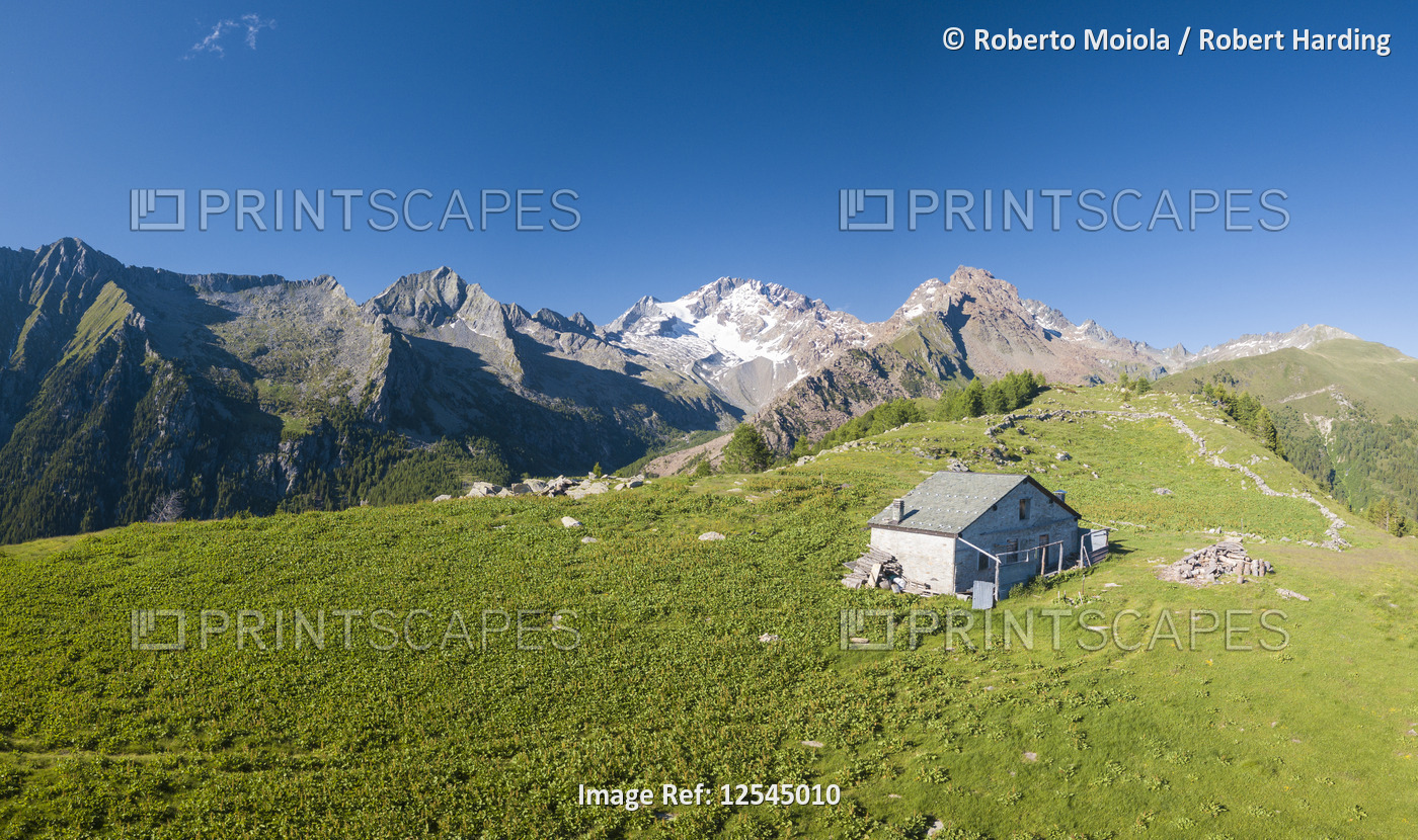 Panoramic aerial view of hut on green meadows, Scermendone Alp, Sondrio province, Valtellina, Rhaeti