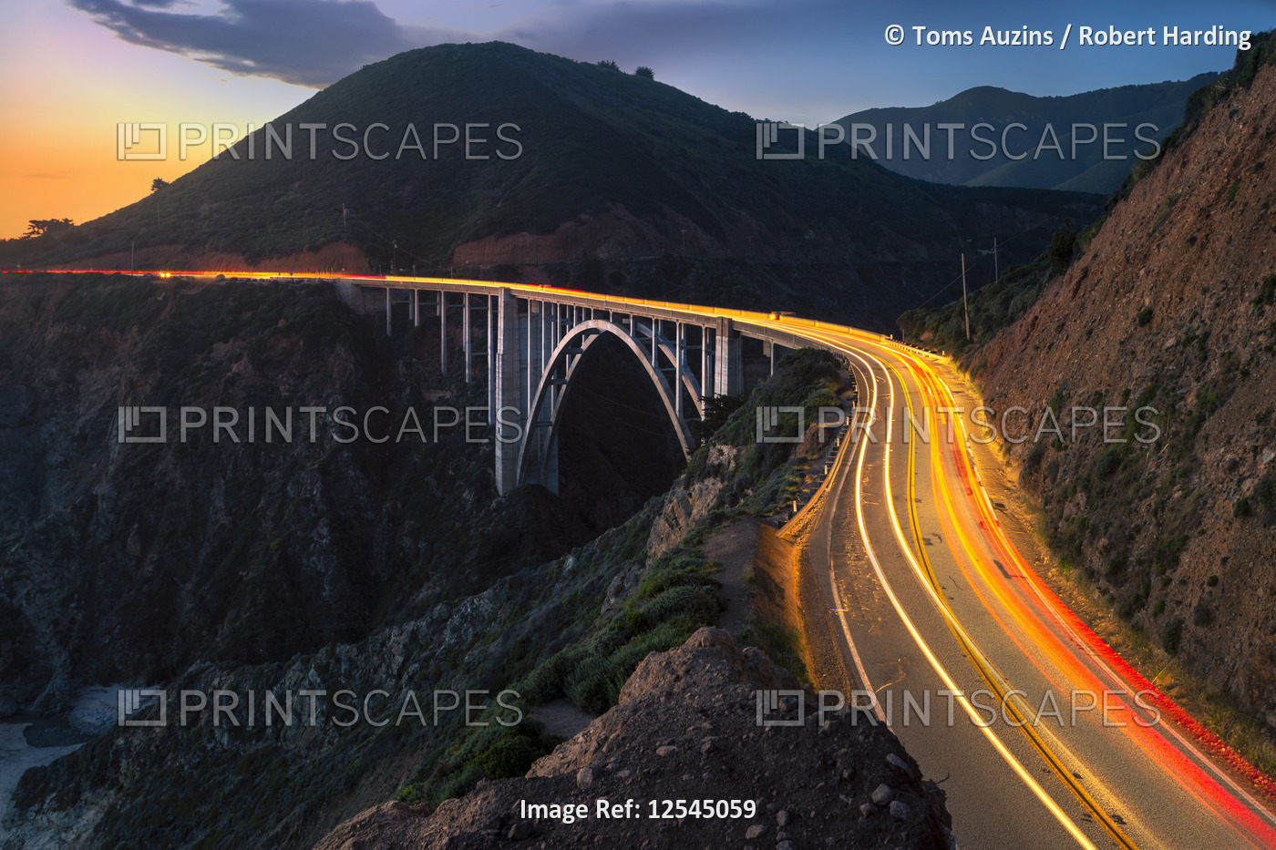 Sunset over Bixby Creek Bridge and car trail lights, Big Sur, California, United States of America, 