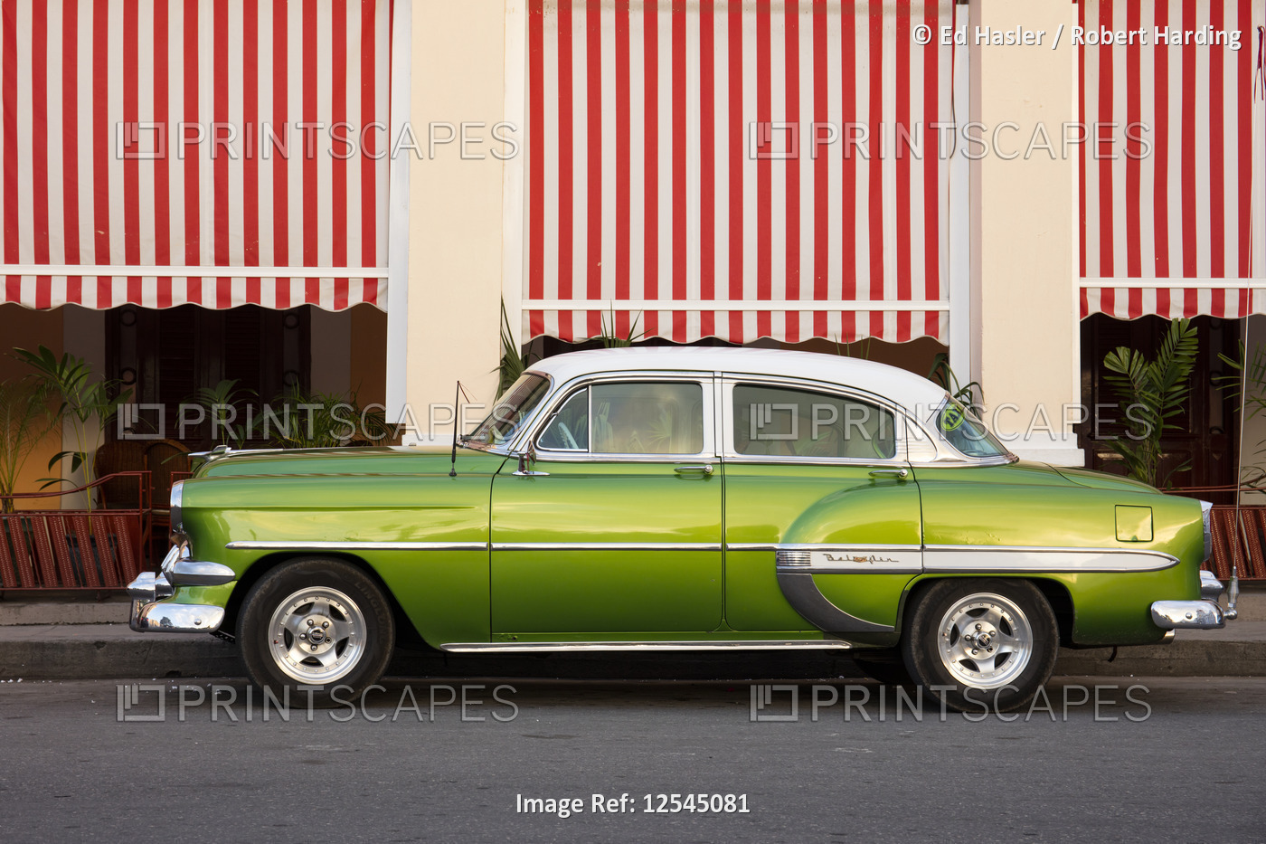 Green vintage American car parked in front of cafe, Cienfuegos, UNESCO World Heritage Site, Cuba, We