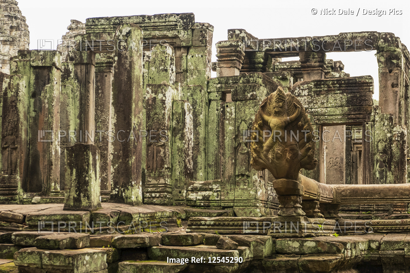 Statue in foreground of ruined Bayon temple, Angkor Wat; Siem Reap, Siem Reap ...