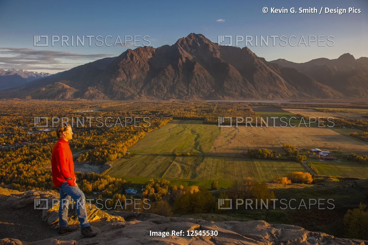 Man viewing scenery from the top of the Butte of farmlands and Pioneer Peak, ...