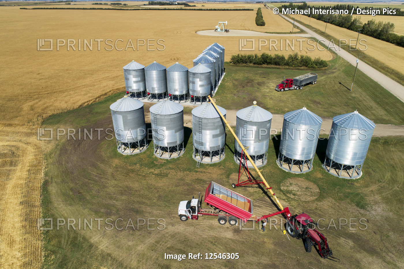Aerial view looking straight down on a truck full of grain filling augers to ...