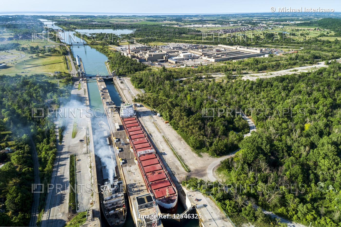 Aerial view of two large laker ships in a canal's lock system; Thorold, ...