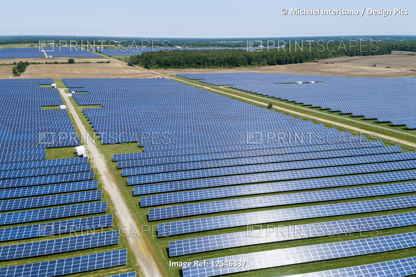 Aerial view of large solar farm with panels reflecting sunlight, West of ...