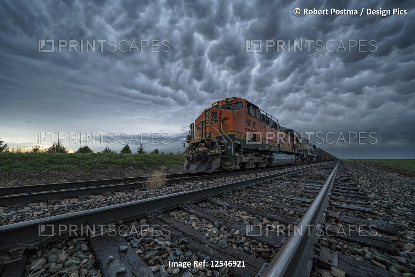 Freight train with mammatus clouds overhead while on a storm chasing tour; ...