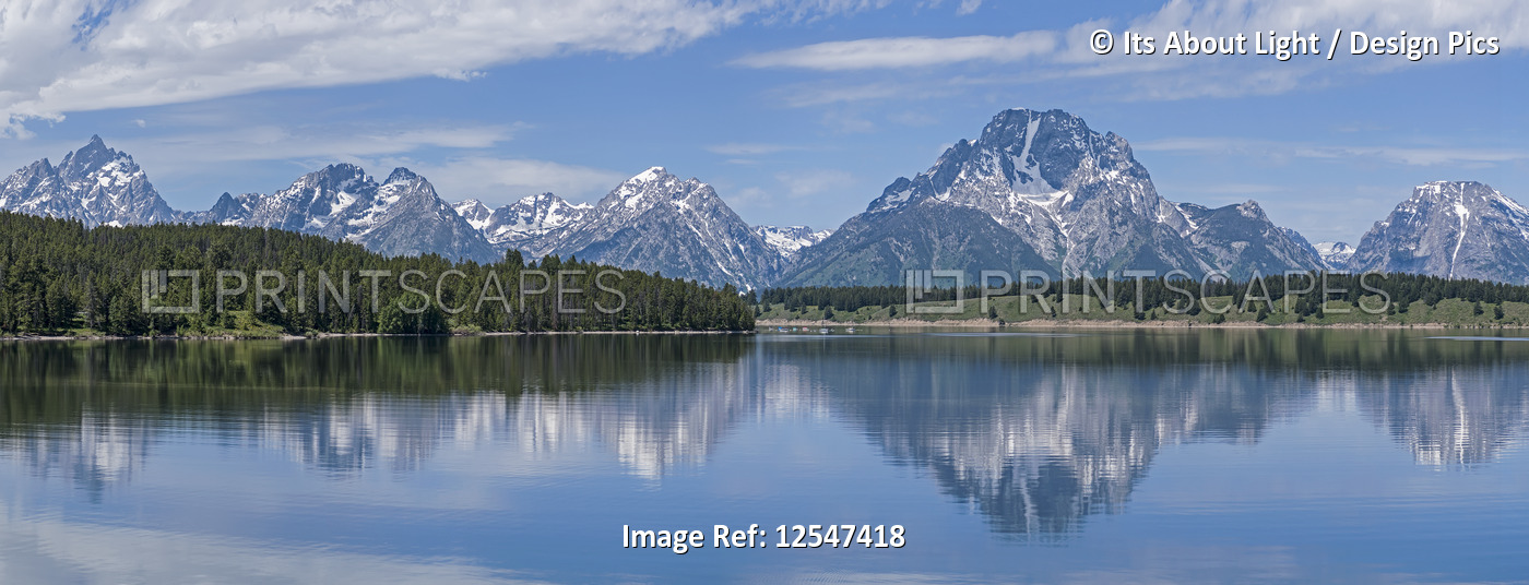 Teton Range reflected in tranquil water, Grand Teton National Park; Wyoming, ...
