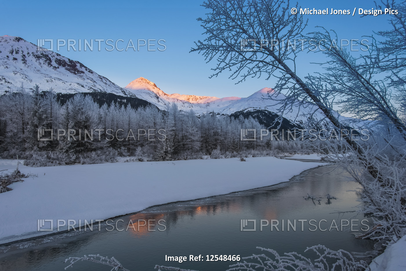 Alpenglow on the mountain tops in Portage Valley as the sun sets on a ...