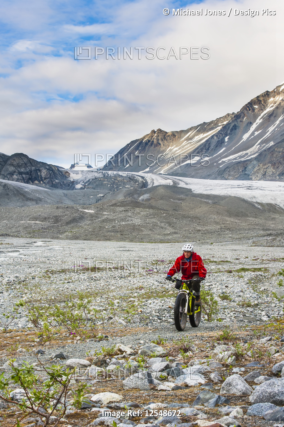 A man riding his fatbike in Gulkana Glacier Valley; Alaska, United States of ...