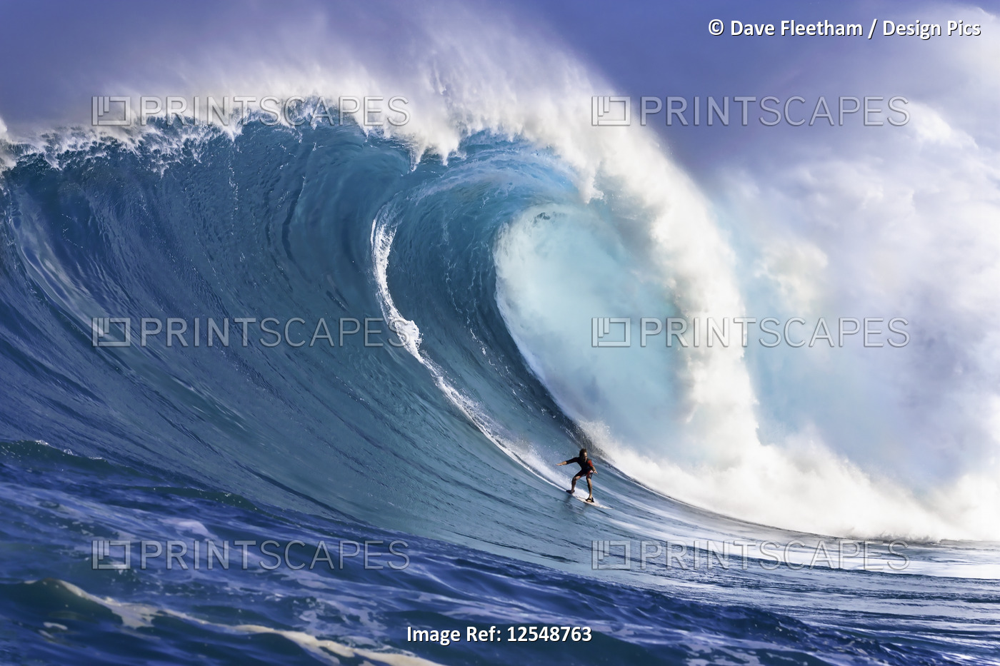 A tow-in surfer drops down the face of Hawaii's big surf at Peahi (Jaws) off ...