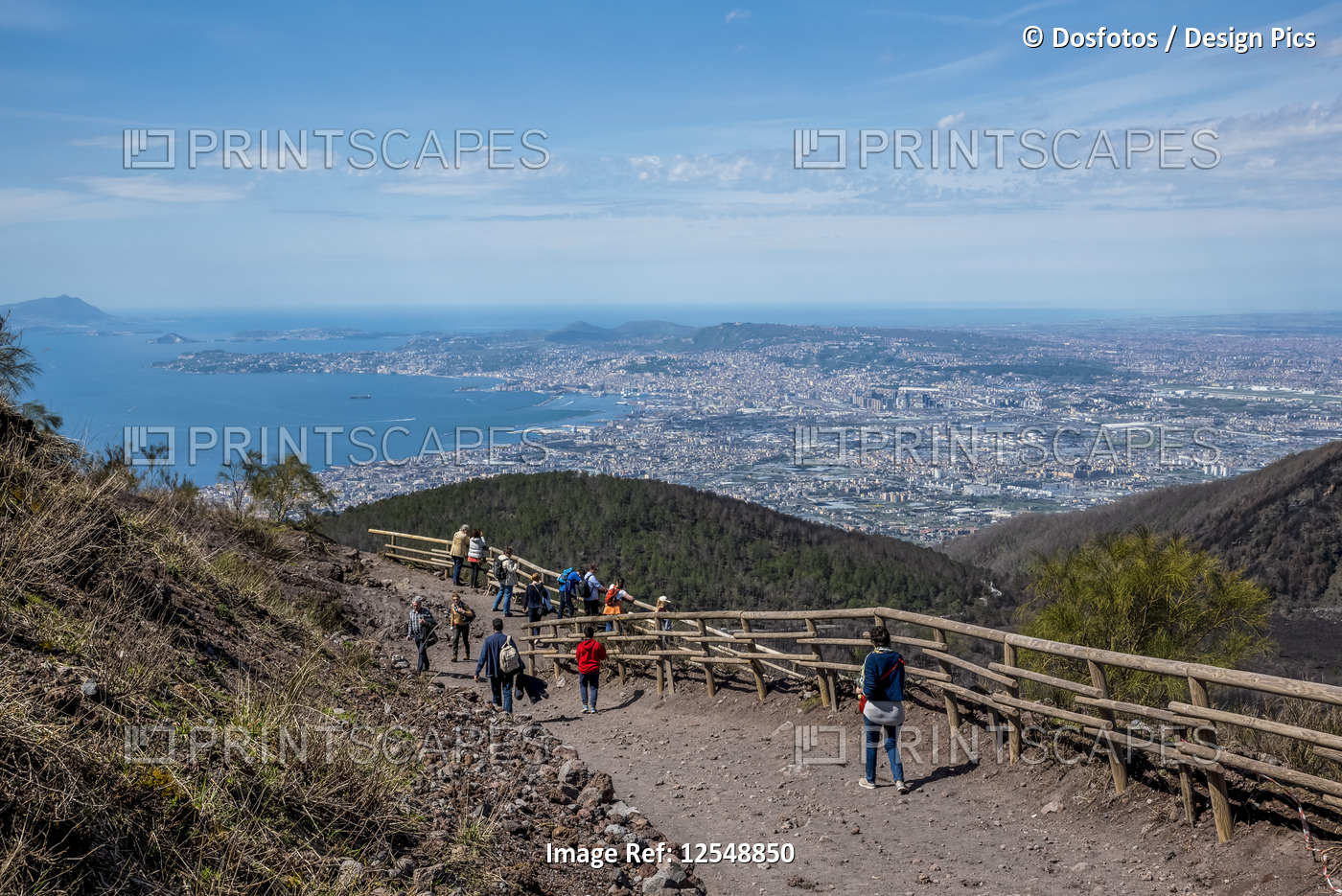 Tourists hiking on a trail with a view of Naples from Mount Vesuvius; Naples, ...