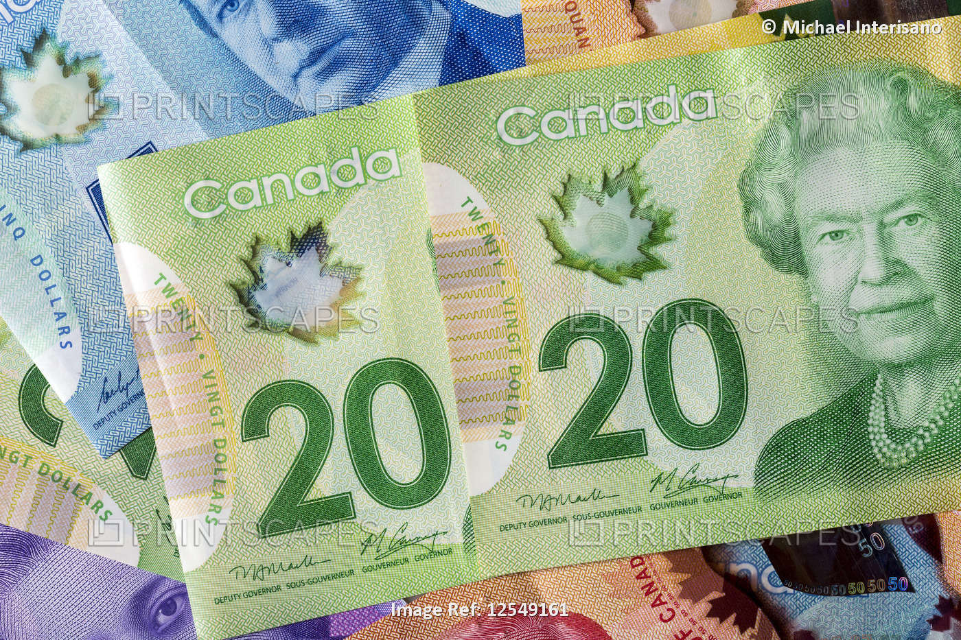 Close-up of two 20 Canadian dollars with other colourful Canadian money in the ...