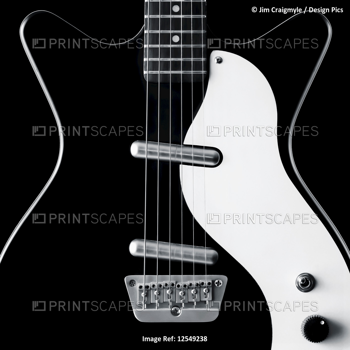Close-up of a black and white electric guitar