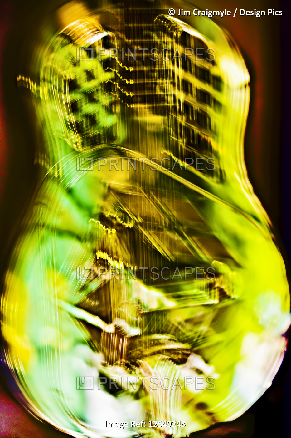 Blur of a tricone guitar in green and yellow
