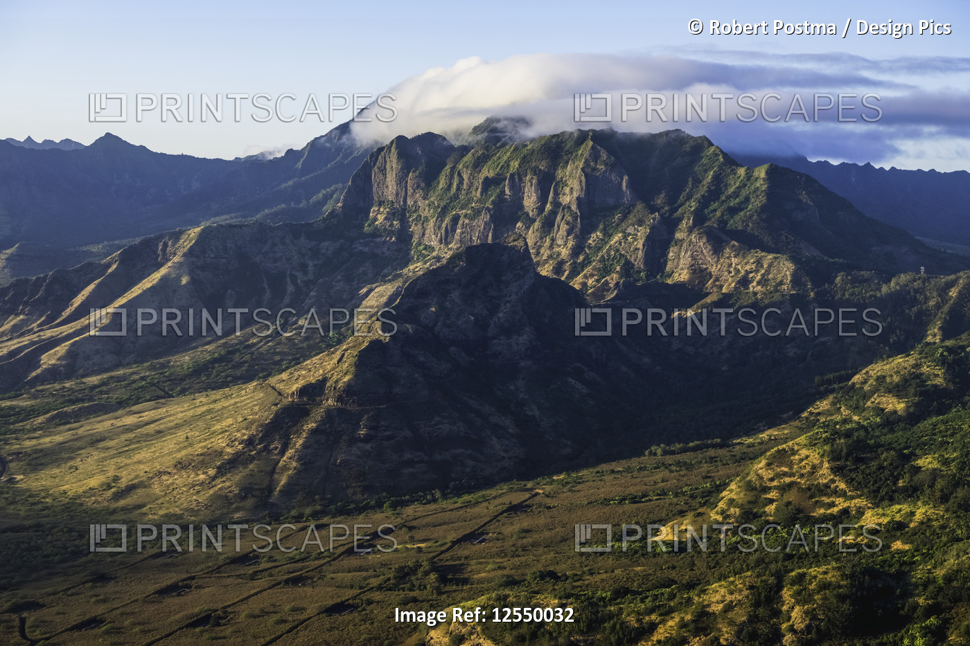 Aerial image of the lush mountains surrounding Oahu being illuminated by late ...