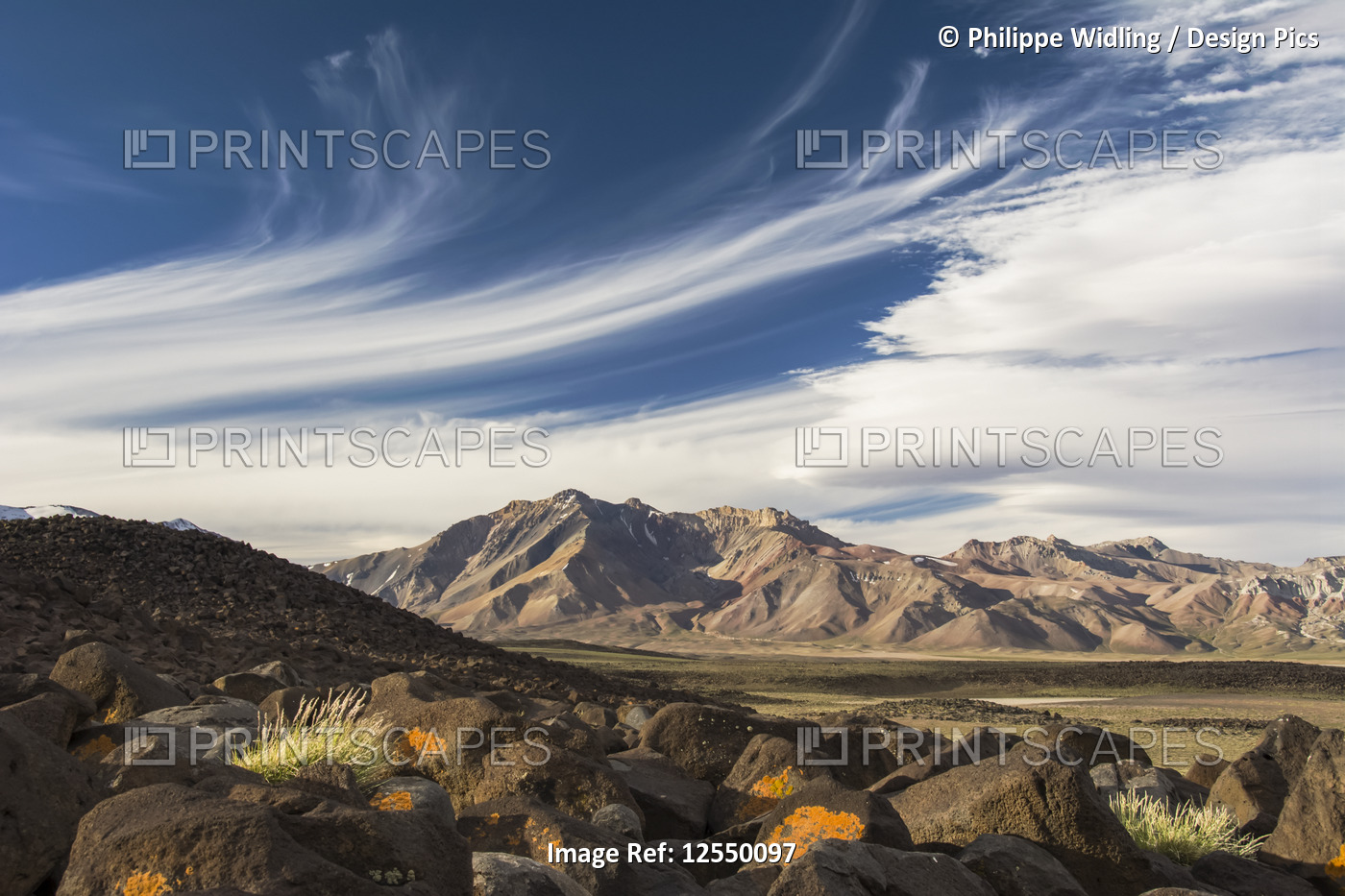 High altitude valley and mountains at sunset, with picturesque cirrus clouds in ...
