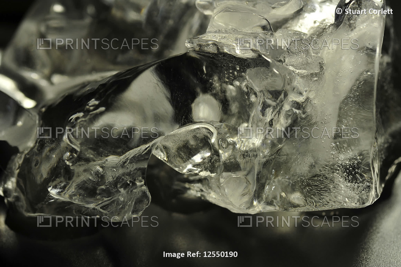 A piece of ice melting against a black background